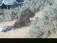 Couple spied in the beach fucking under the sun umbrella