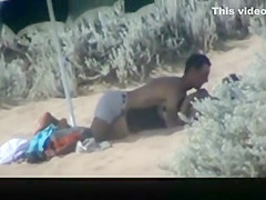 Couple spied in the beach fucking under the sun umbrella