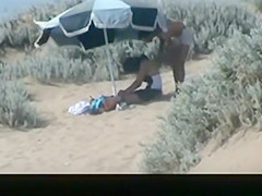 Couple spied in the beach fucking under the sun umbrella
