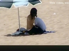 Couple spied in the beach fucking under the sun umbrella