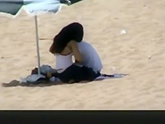 Couple spied in the beach fucking under the sun umbrella