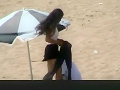 Couple spied in the beach fucking under the sun umbrella