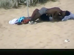 Couple spied in the beach fucking under the sun umbrella