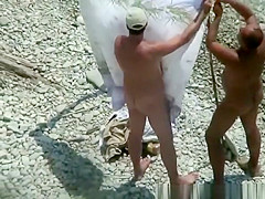 Naked man fucks his nude wife in beach