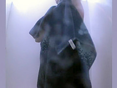 Mature lady showers in a beach cabin