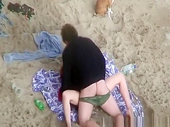 Clothed woman fucked in the beach
