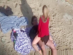 Clothed woman fucked in the beach