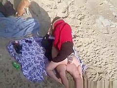 Clothed woman fucked in the beach