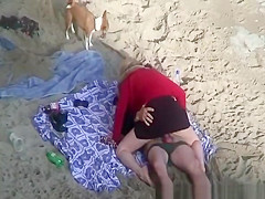 Clothed woman fucked in the beach