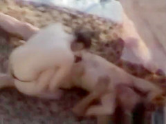 Topless woman spied in the rocky beach