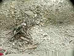 Voyeur hidden in the top of the cliff secretly film nudist couple