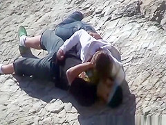 Girl masturbates her guy in the rocks