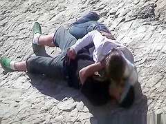 Girl masturbates her guy in the rocks