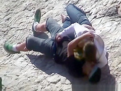 Girl masturbates her guy in the rocks