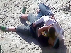 Girl masturbates her guy in the rocks
