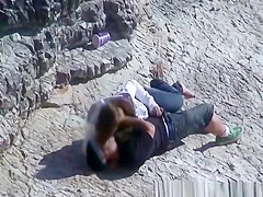 Girl masturbates her guy in the rocks