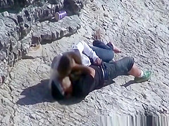 Girl masturbates her guy in the rocks