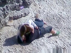 Girl masturbates her guy in the rocks