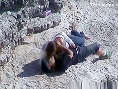 Girl masturbates her guy in the rocks