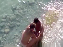 Couple fucking in the water and shore