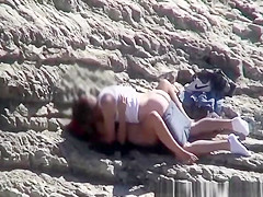 Couple spied fucking in rocky beach