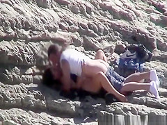 Couple spied fucking in rocky beach