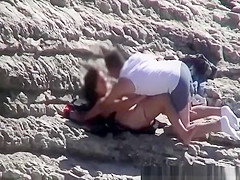 Couple spied fucking in rocky beach