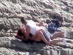 Couple spied fucking in rocky beach
