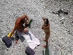 Black hair nudist and her man at beach