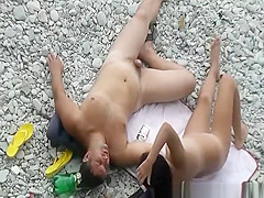 Black hair nudist and her man at beach