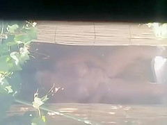 Mature woman spied during a shower