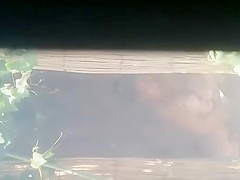 Mature woman spied during a shower