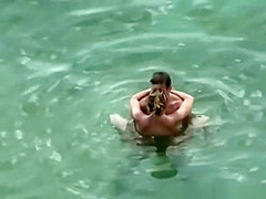 Nudist couple secretly filmed fucking in the water