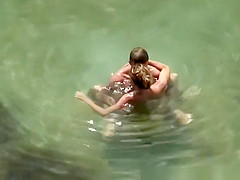 Nudist couple secretly filmed fucking in the water