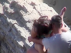 Couple playing with eachother at beach