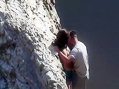 Couple playing with eachother at beach