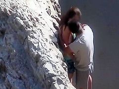 Couple playing with eachother at beach