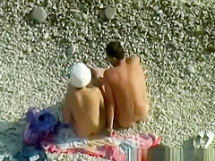 Nudist woman wanks her nude man's penis