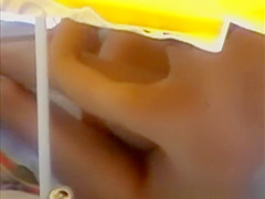 Nudists having sex under the sun umbrella