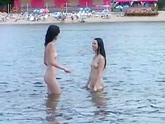 Two skinny nudist teens frolic around the beach
