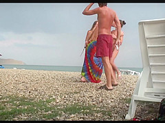 Voyeur on public beach. Girls posing