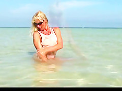 Hot milf posing in wet see through bikini on the beach part2