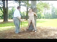 Woman tied to tree for light bondage