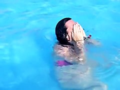 Sweet brunette doll has lost her bikini panty in the pool