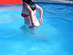 Sweet brunette doll has lost her bikini panty in the pool
