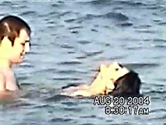 Sassy couple voyeured in the water seems to be fucking