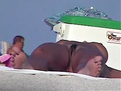Tanned pierced marvelous babe getting recorded on the nudist beach