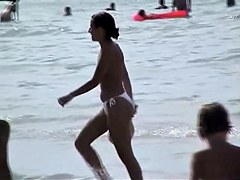 Topless babes getting caught on tape while acting naughty on the public beach
