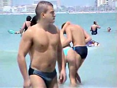 Topless babes getting caught on tape while acting naughty on the public beach