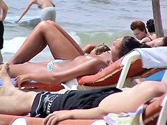 Topless babes getting caught on tape while acting naughty on the public beach